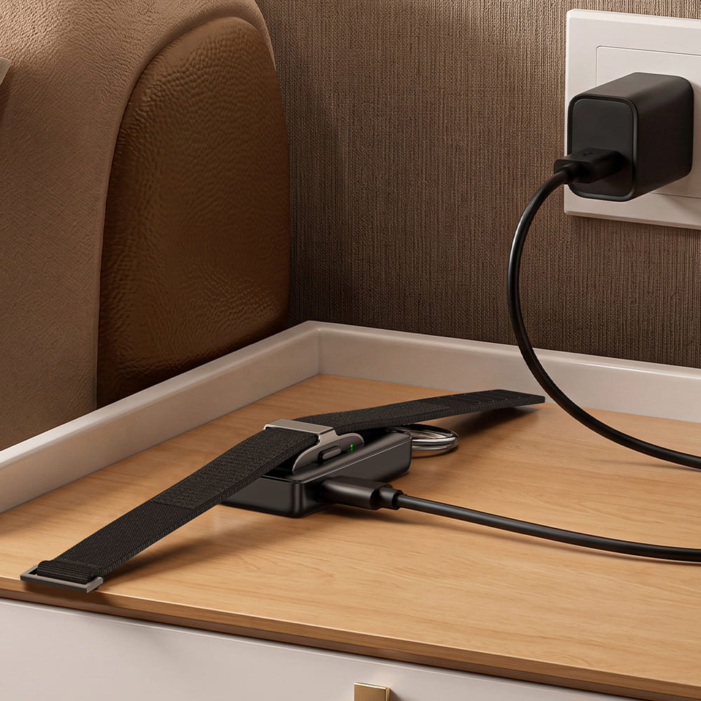 Hume Band 1.0 nightstand charger plugged into wall adapter with SwanScout 513