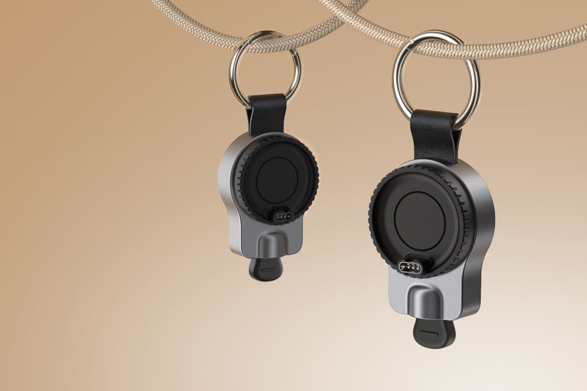 Sleek and elegant design showcasing two SwanScout 510GM portable Garmin watch chargers in a suspended display highlighting premium minimal aesthetics